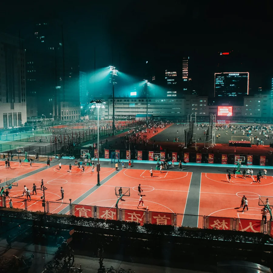 students playing basketball at night in Beijing