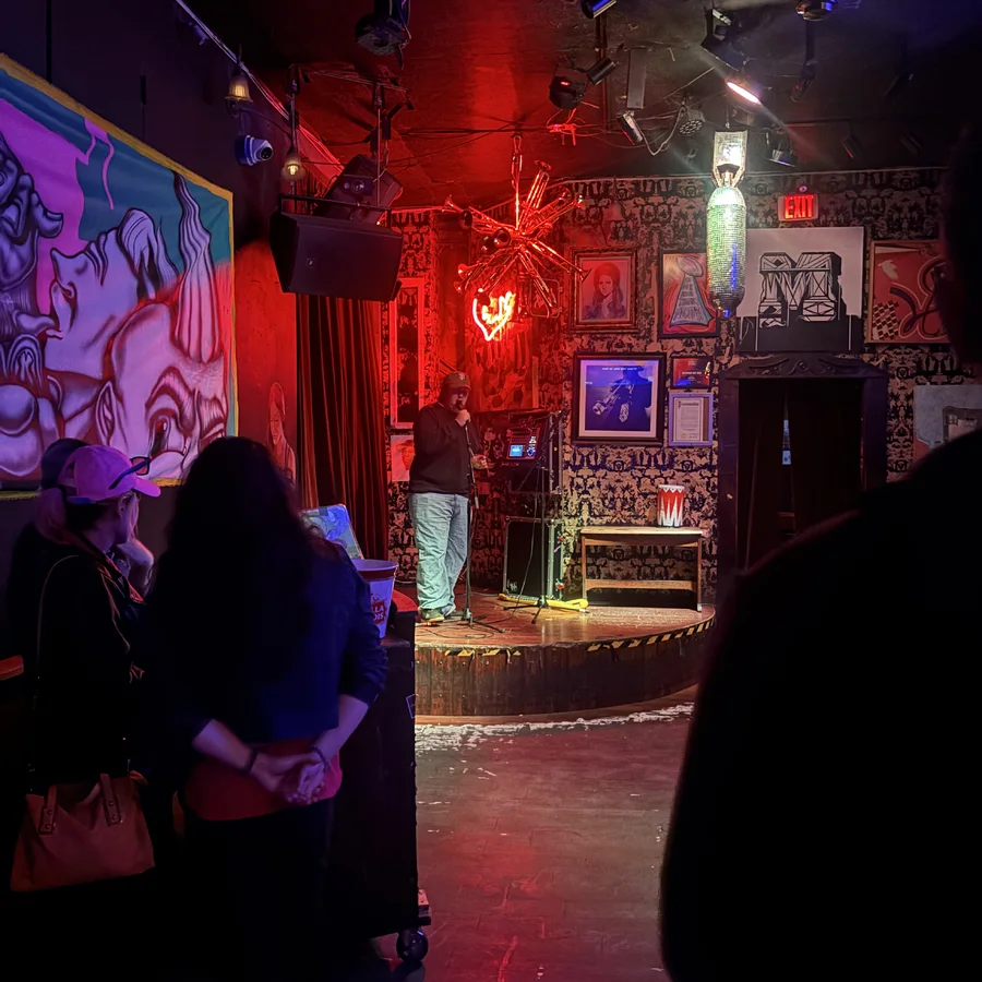 crowd gathered inside a red-lit Lower Haight venue