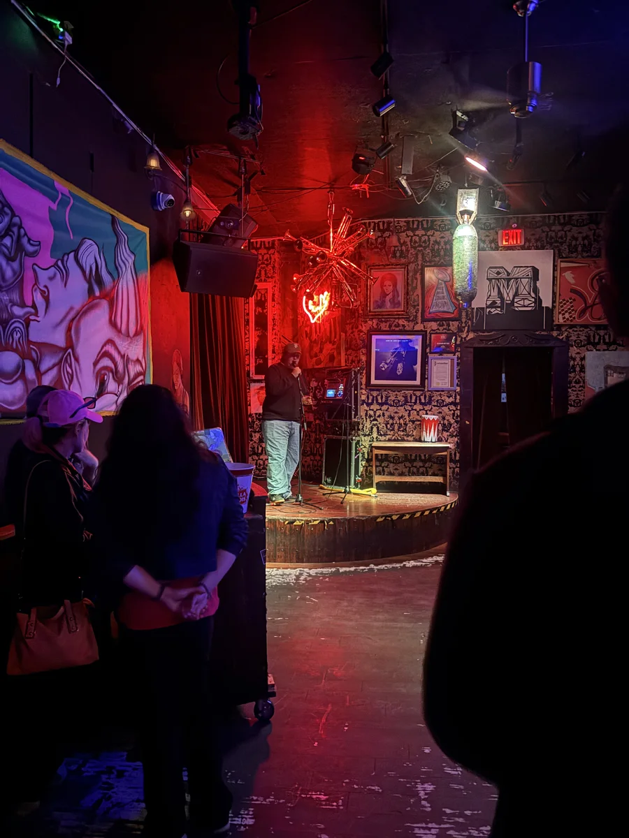 crowd gathered inside a red-lit Lower Haight venue