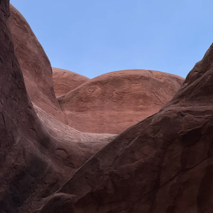 red rock walls opening onto blue sky