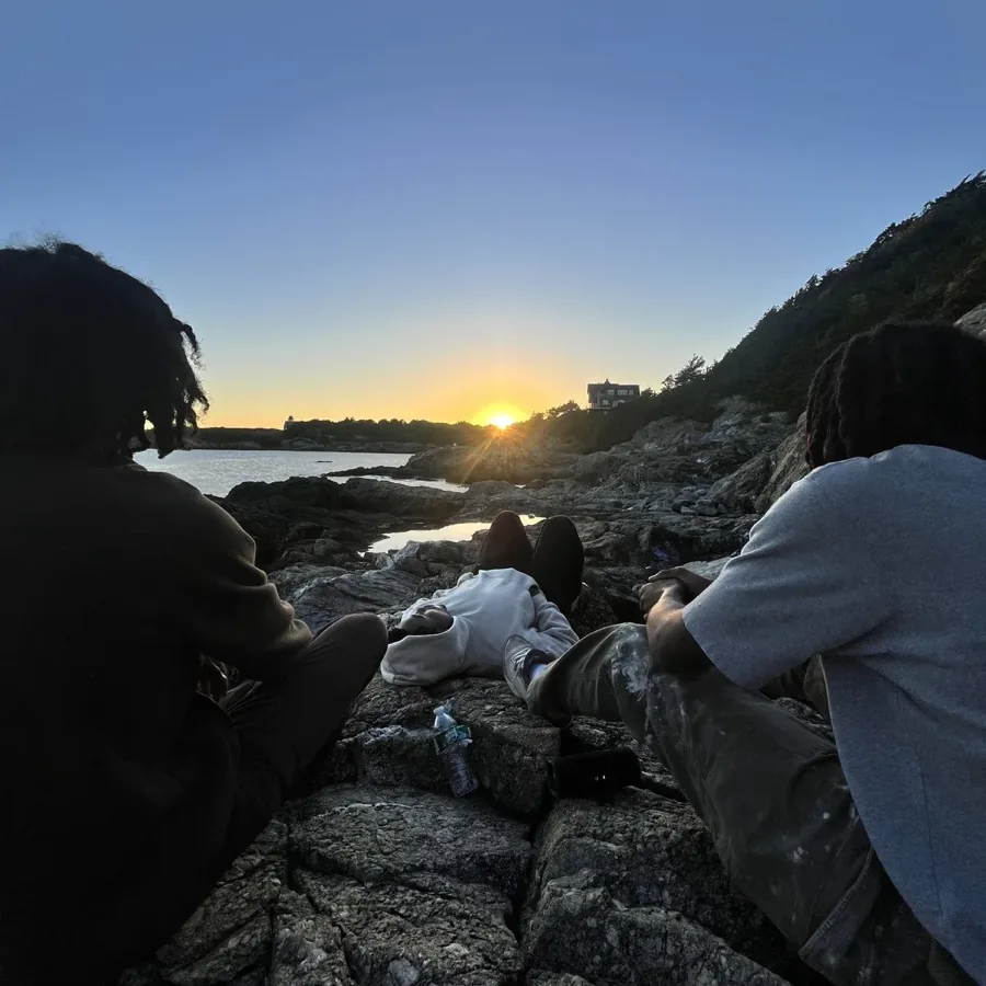 friends on the rocks at sunset