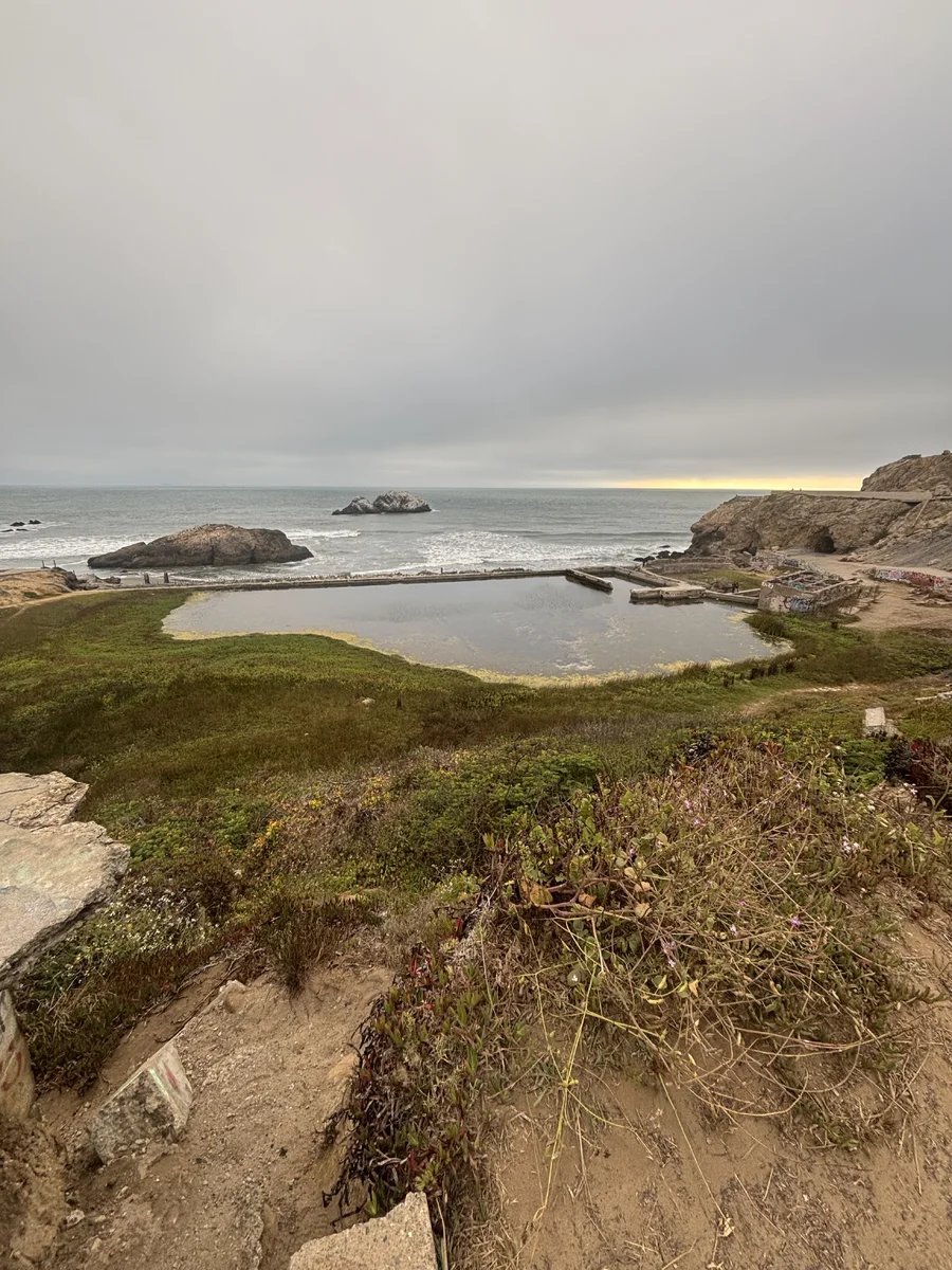 Sutro Baths below a foggy Pacific sunset